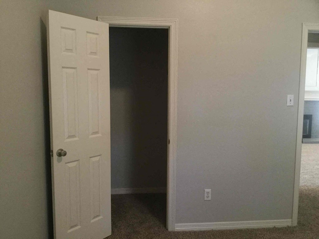 an open door in a room with a closet