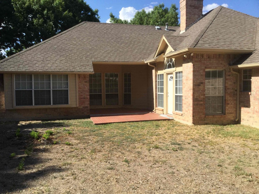 a front view of a brick house with a porch