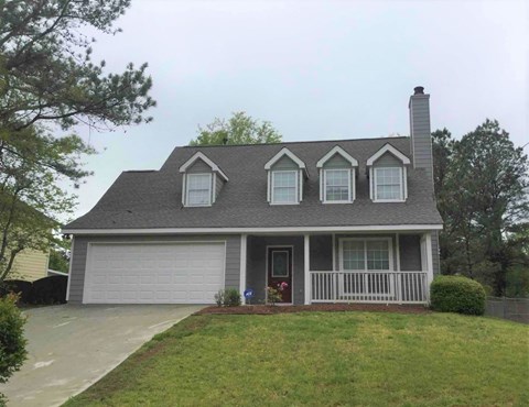 a house with a front porch and a lawn
