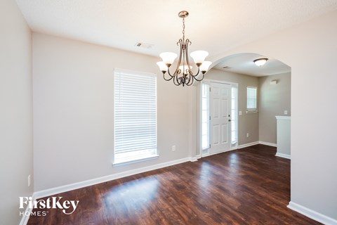 a living room with a hard wood floor and a chandelier