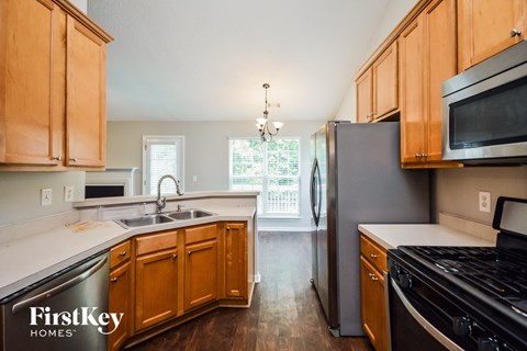 a kitchen with wooden cabinets and stainless steel appliances