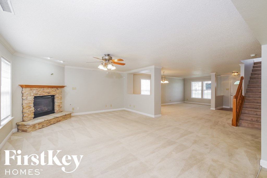 the living room and family room with a fireplace