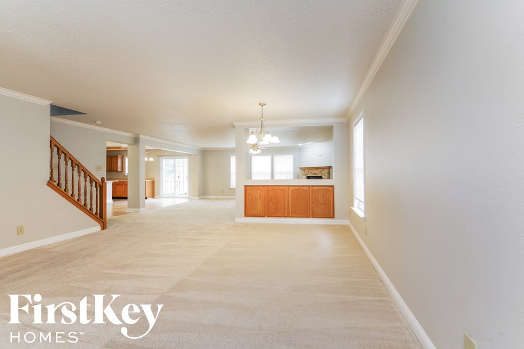 the spacious living room and dining room are open to the kitchen and family room