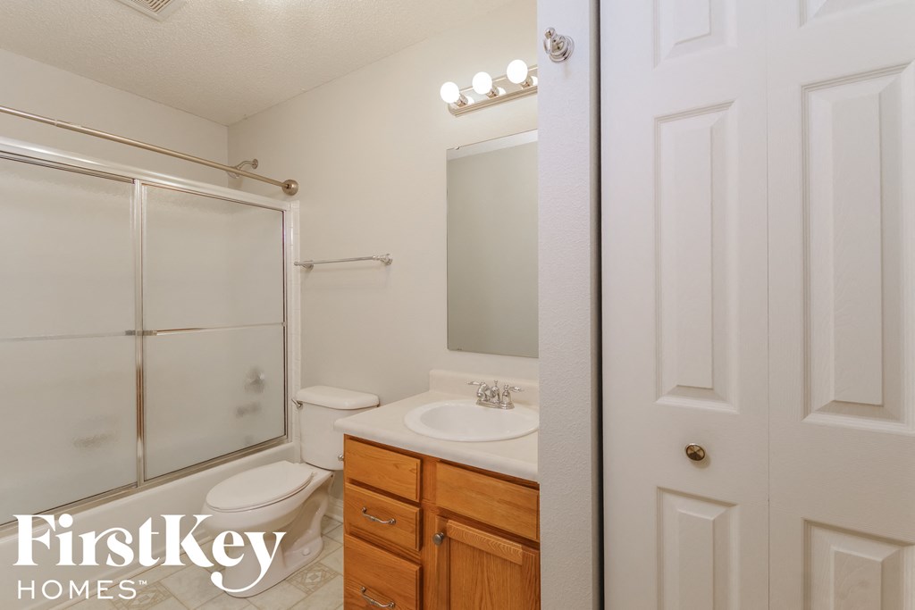 a bathroom with a sink toilet and a shower