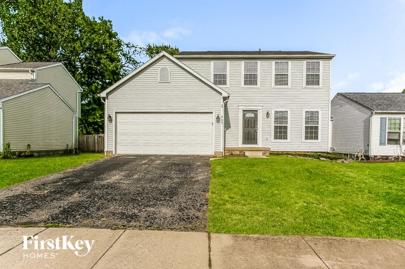 a white house with a gravel driveway