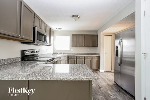 a kitchen with stainless steel appliances and granite counter tops