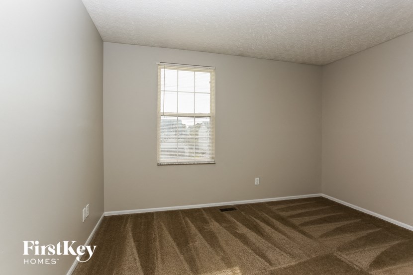 the living room of an empty house with a window