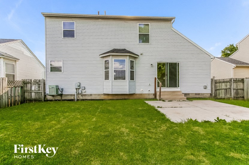 a white house with a yard in front of it