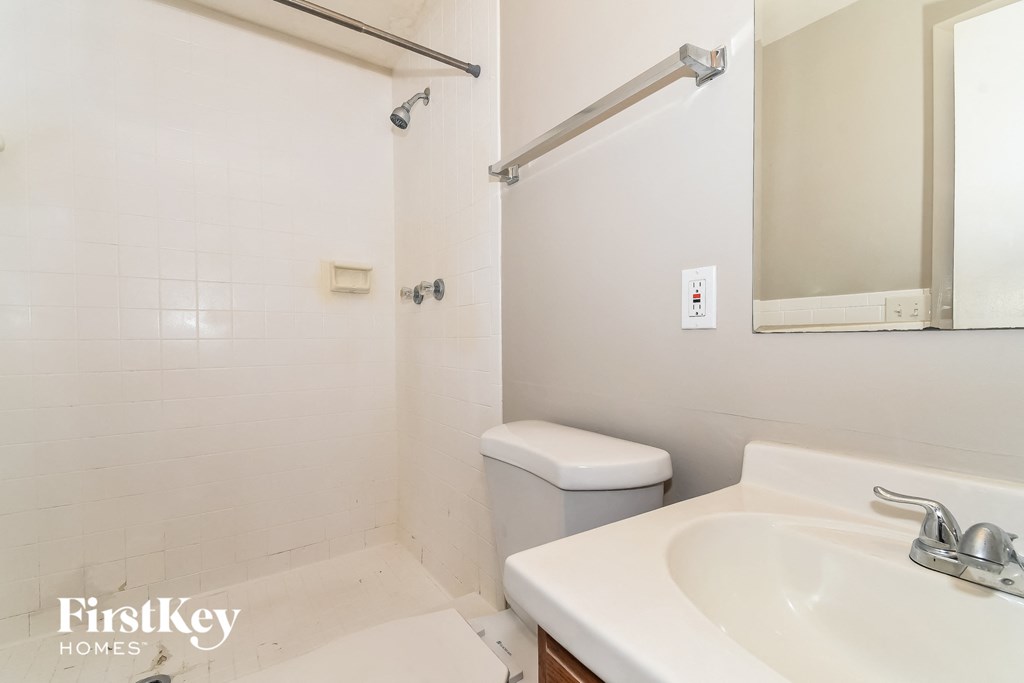 a bathroom with a sink and a toilet and a shower