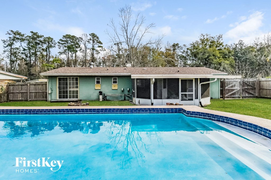 a house with a swimming pool in front of it