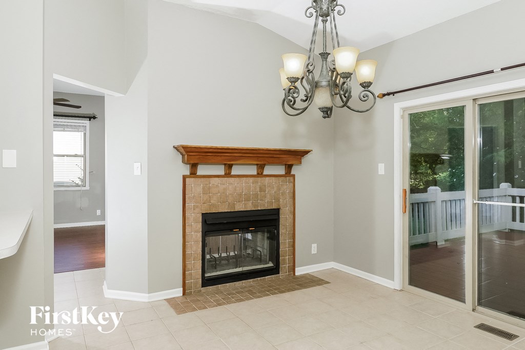 a living room with a fireplace and a sliding glass door