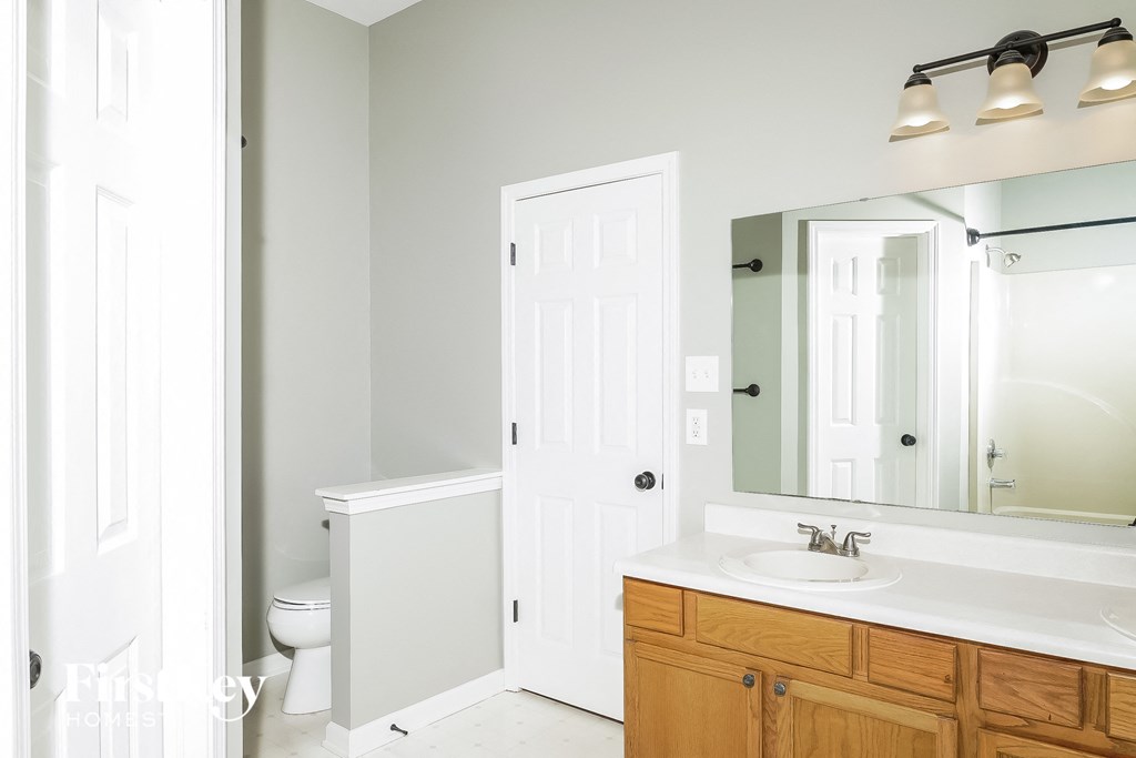 a bathroom with a sink and a mirror and a toilet