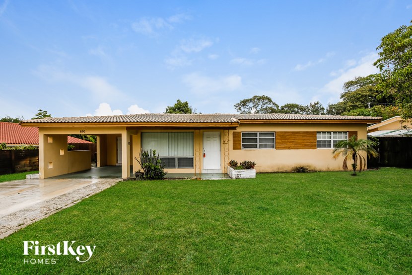 A house with a red roof and a white door is for sale.