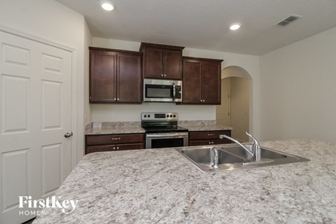 a kitchen with granite counter tops and a sink