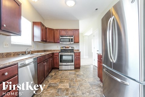 a kitchen with stainless steel appliances and wooden cabinets