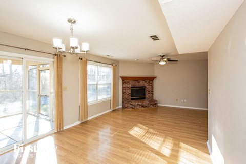 A living room with a fireplace and sliding glass doors.