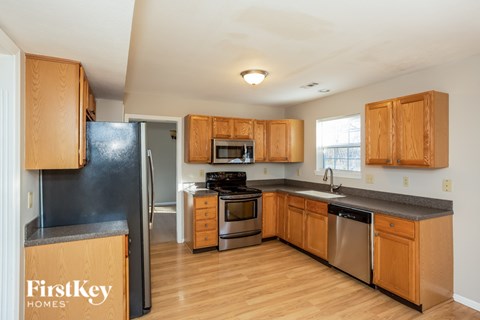 A kitchen with wooden cabinets and stainless steel appliances.