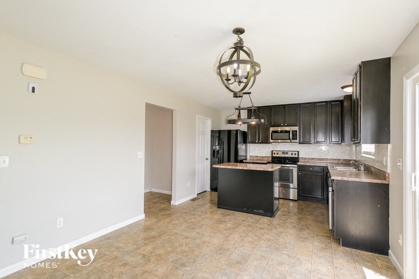 a large kitchen with black cabinets and a counter top