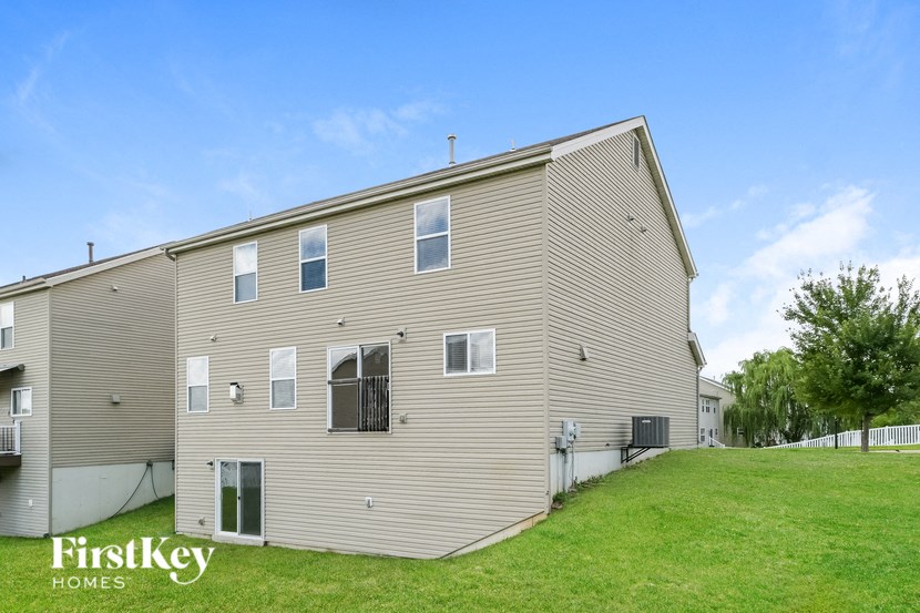 the back of a house with a green lawn