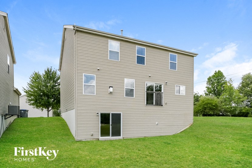 the back of a house on a green lawn