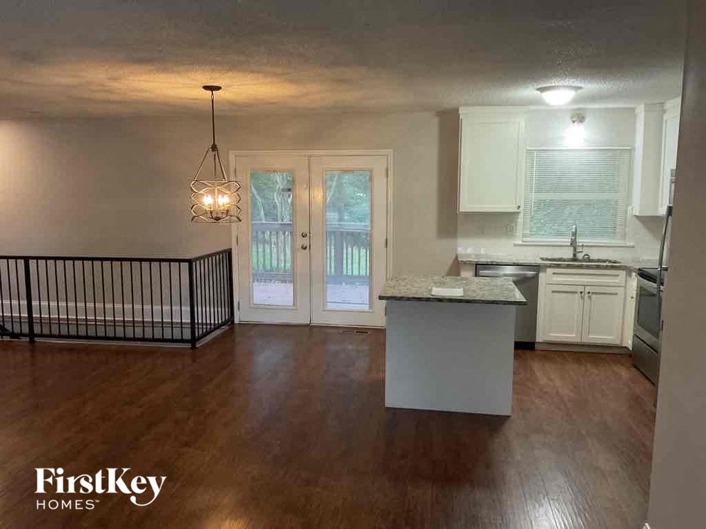 A kitchen with a white island in the middle of the room.