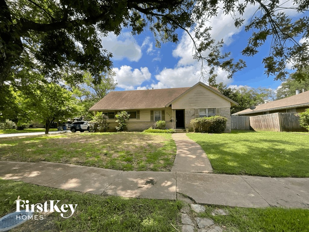 a home with a sidewalk and lawn in front of it