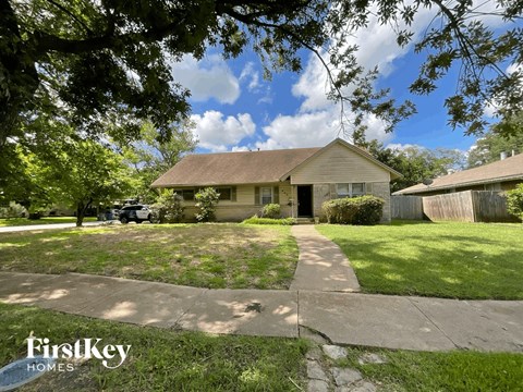 a home with a sidewalk and lawn in front of it