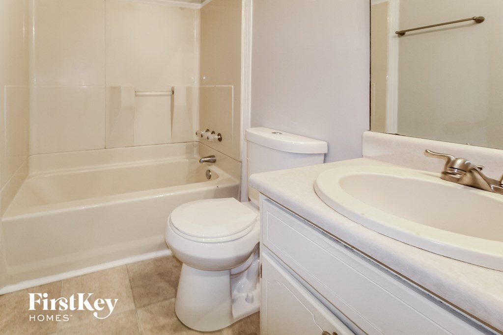a bathroom with a sink toilet and a bath tub