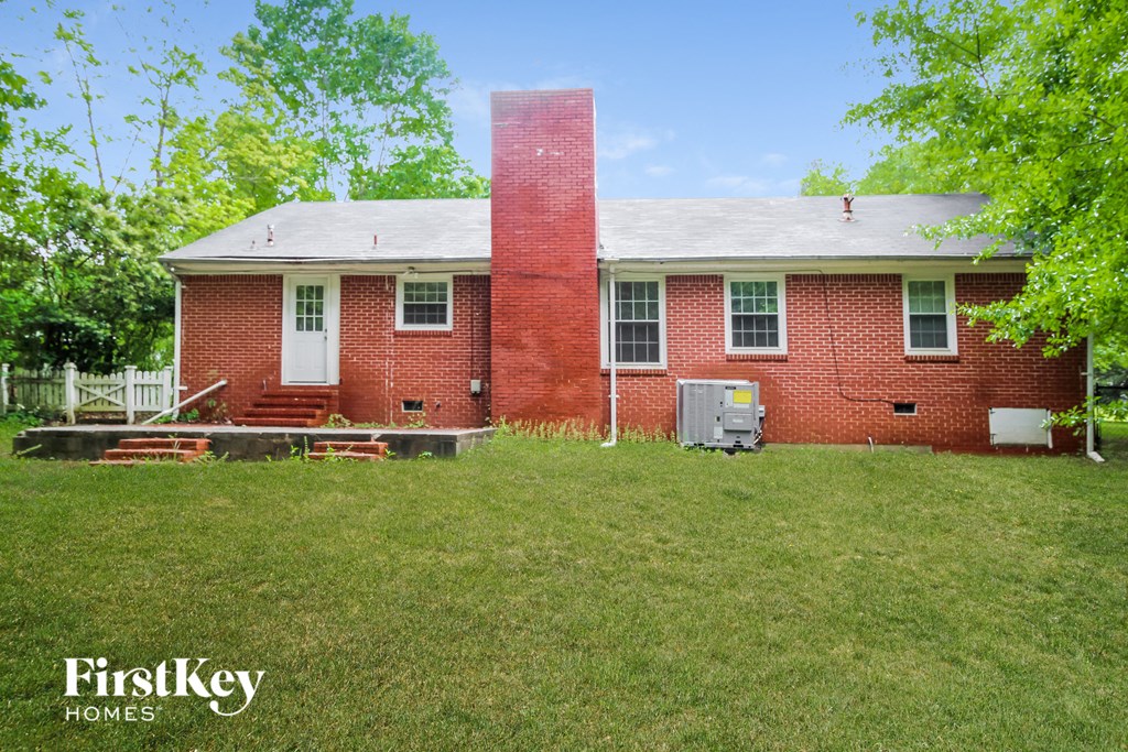 an old brick house with a chimney on the front