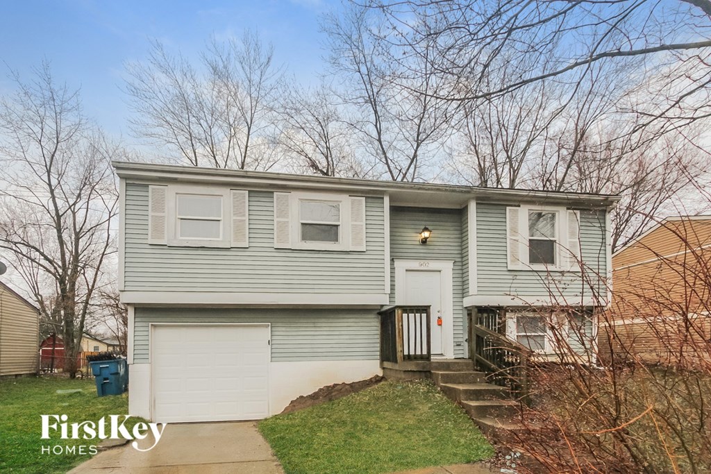 A two-story house with a garage is for sale.