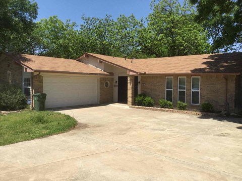 A house with a brown roof and a white garage door.