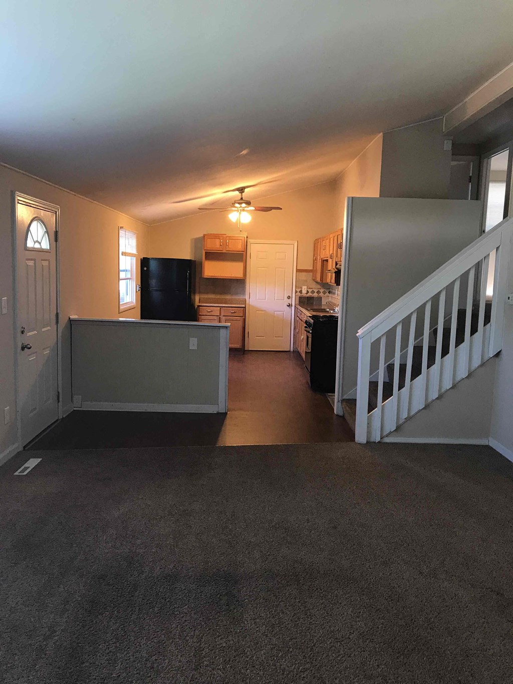A living room with a staircase on the right side.