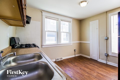 A kitchen with a stainless steel sink and a window.
