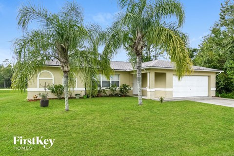 a home with palm trees in front of it