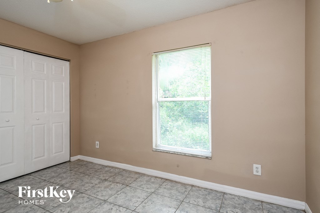 the living room of a home with a window and a white door