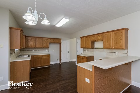A kitchen with wooden cabinets and a white countertop.