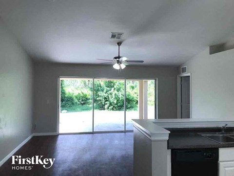 A kitchen with a sink and a fan on the ceiling.