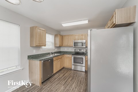 a kitchen with wooden cabinets and stainless steel appliances