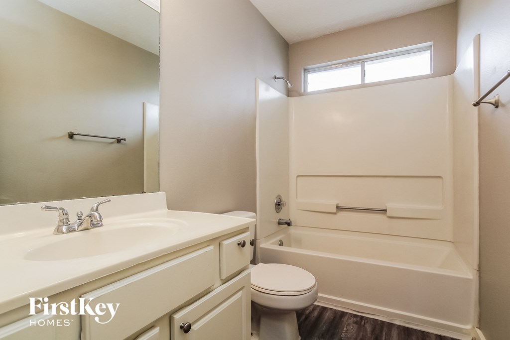 a bathroom with a sink toilet and a bath tub