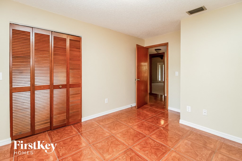 a living room with a large closet and a door to a hallway