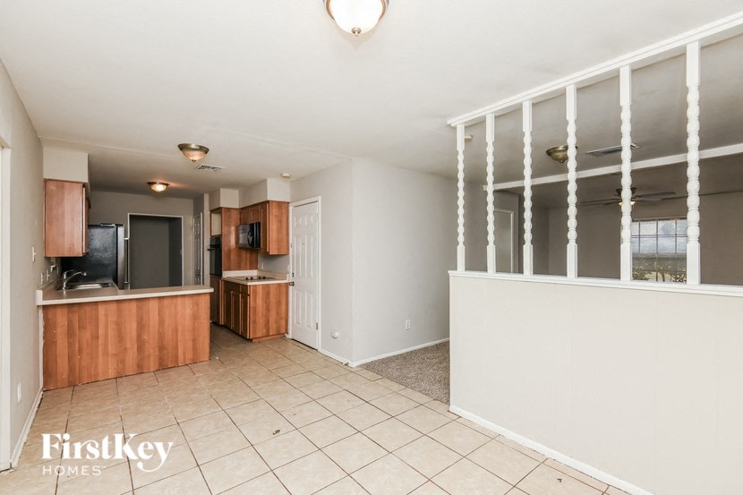 a kitchen and a living room with a counter and a sink