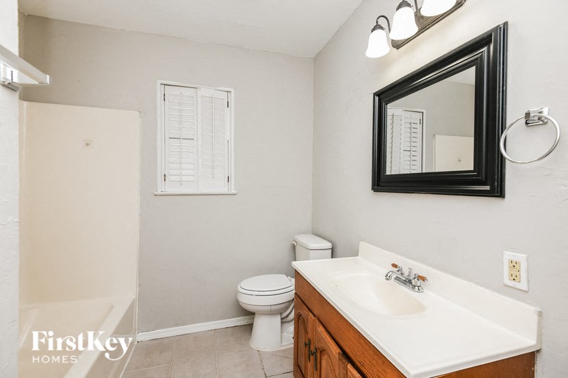 a bathroom with a sink toilet and a mirror