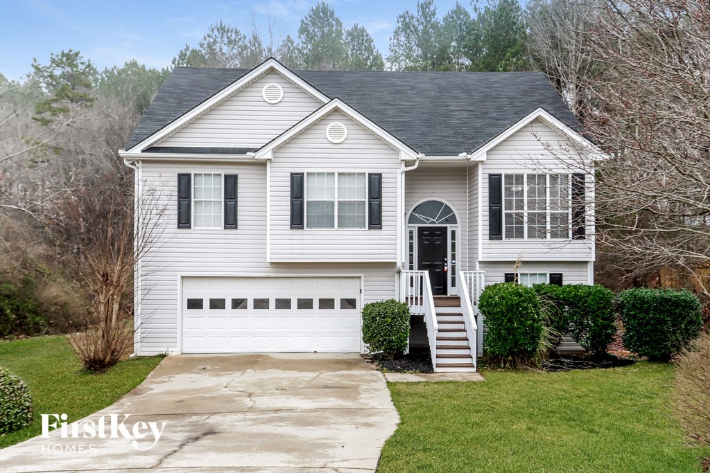 A two-story house with a garage and a front porch.