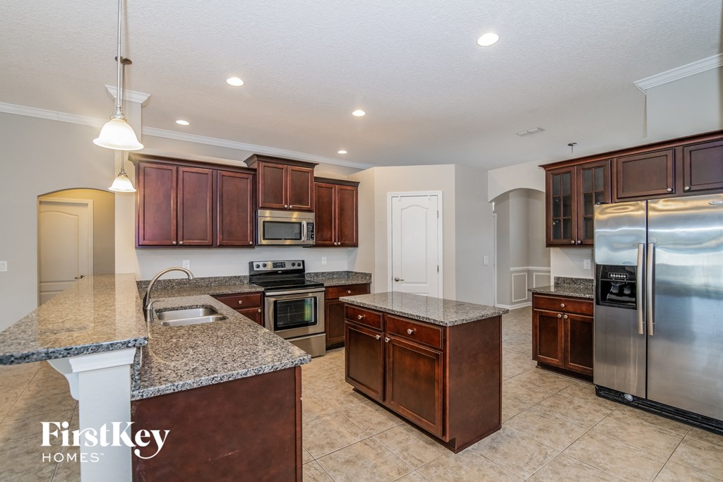 a kitchen with granite counter tops and stainless steel appliances