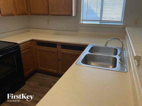 A kitchen with a sink and a window.