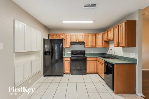 a kitchen with black appliances and wooden cabinets