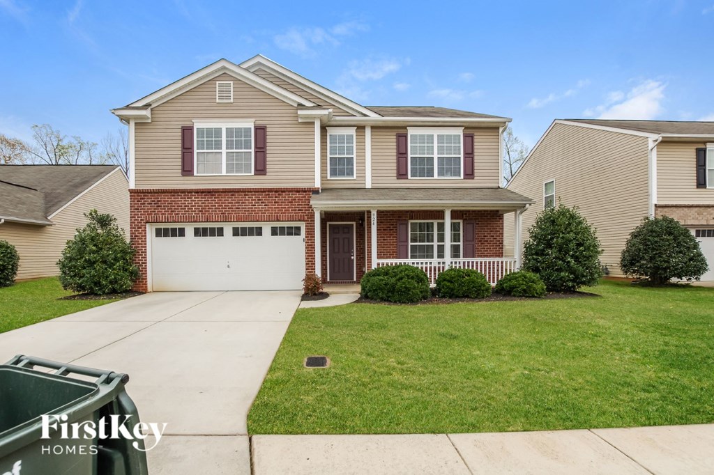 A two-story house with a garage is for sale.
