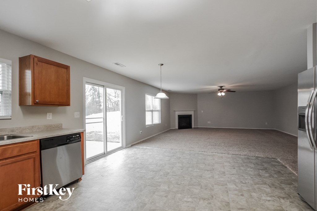 A kitchen with a washing machine and a refrigerator.