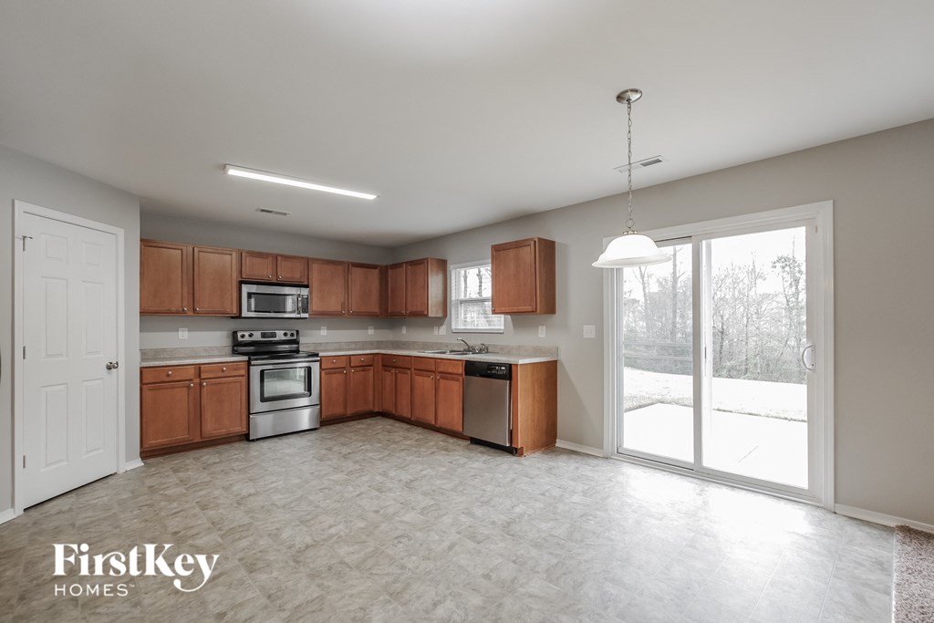 A kitchen with wooden cabinets and a white ceiling.