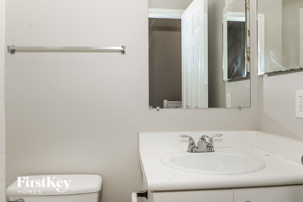 a small bathroom with a sink and a mirror